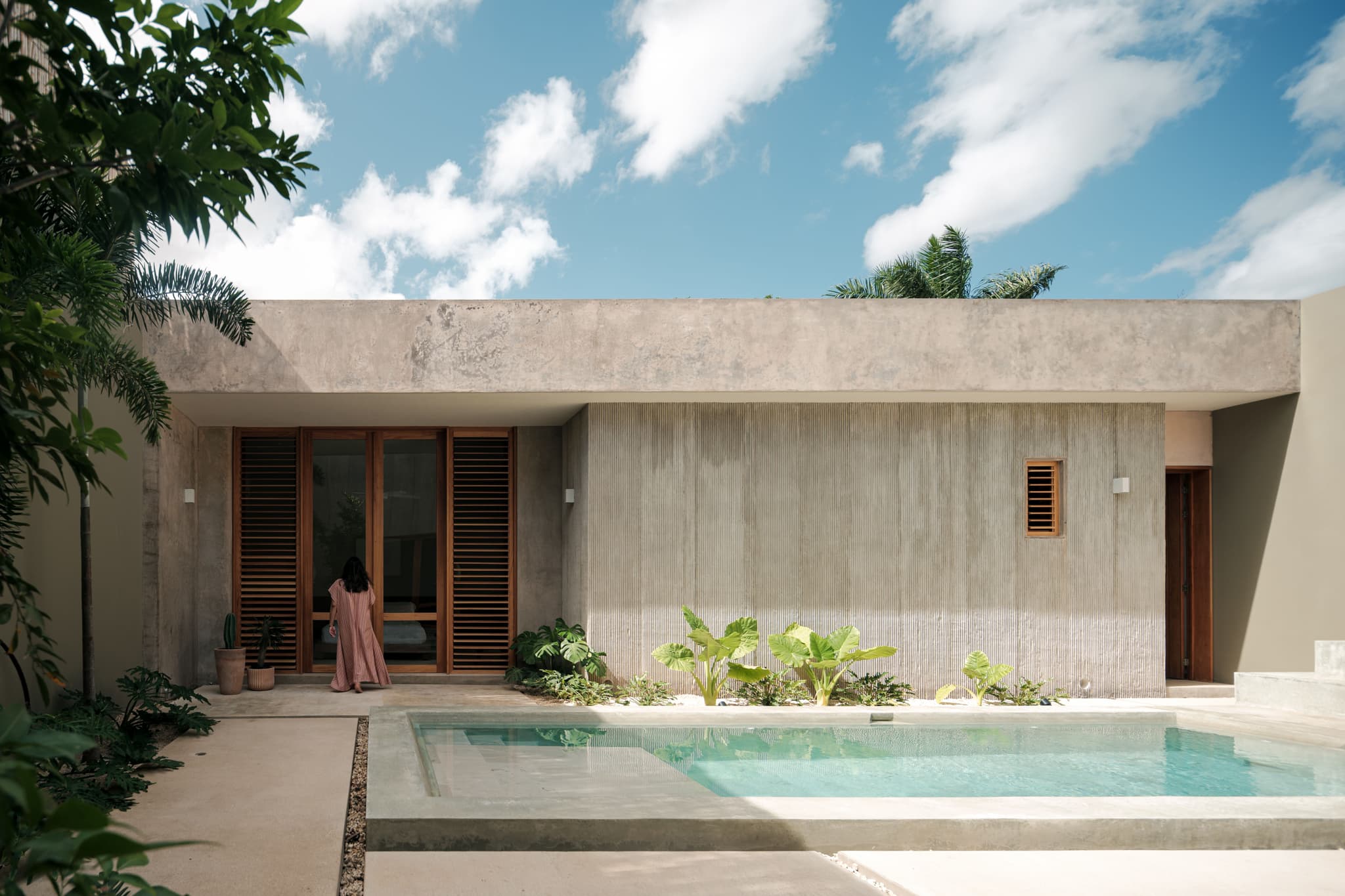 Dolores (2024) by FMT Estudio. Featuring textured concrete walls and custom-crafted tornillo wood windows with shutters. These elements effectively control light and airflow while emphasising durability, blending functionality with craftsmanship. Architects: Orlando Franco and Zaida Briceño