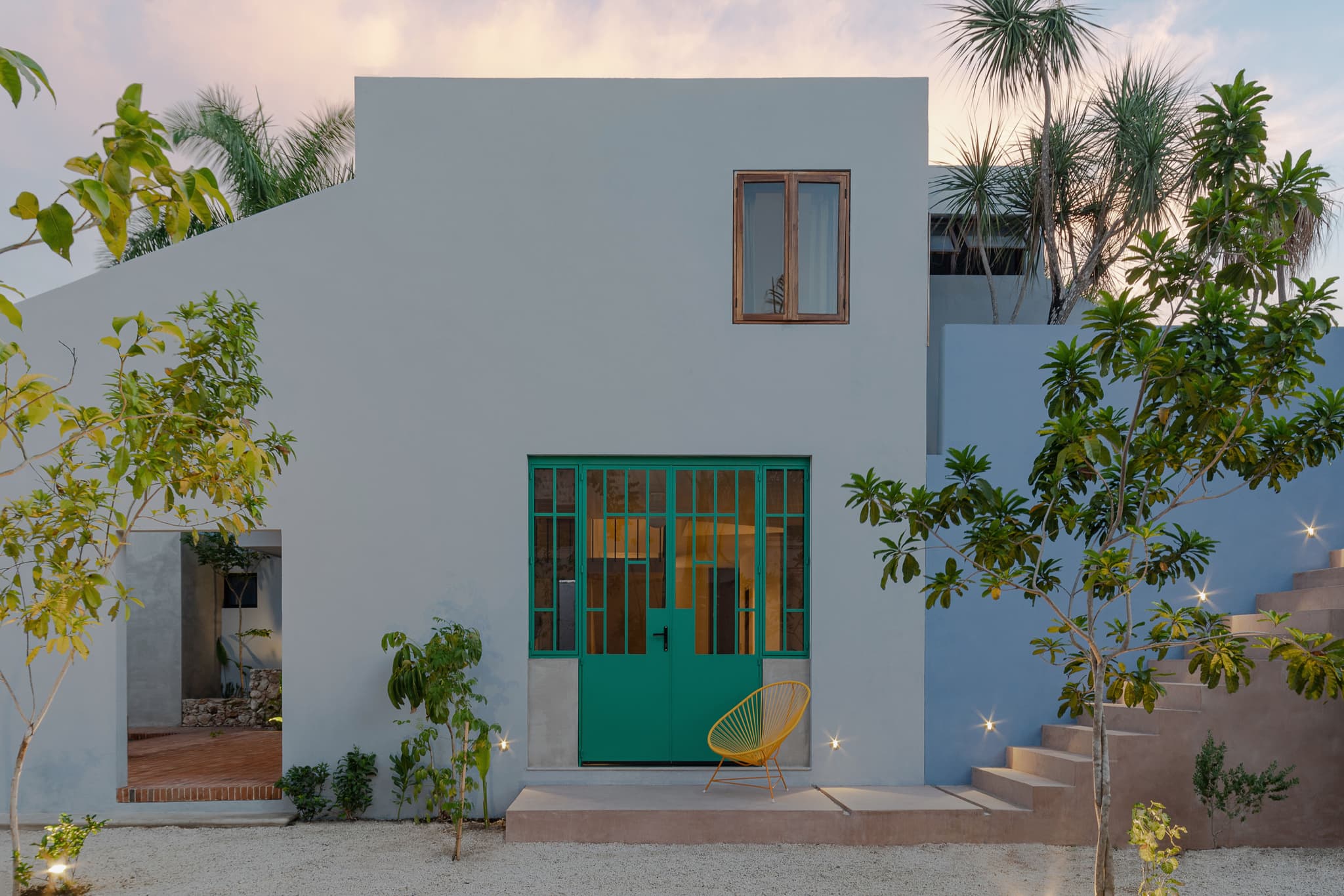 La Posmoderna (2023) by FMT Estudio. Integrated with the surrounding landscape, offering comfortable outdoor spaces for contemplation and living. Native trees planted throughout enhance the natural ambience.